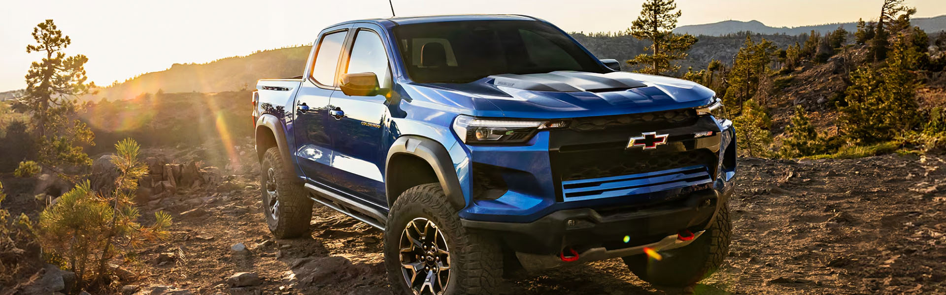 2026 Chevy Colorado ZR2 midsize truck with all-terrain tires on a rocky outdoor trail.